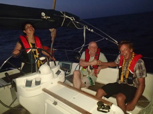Night sailing in the Caribbean with happy crew members 